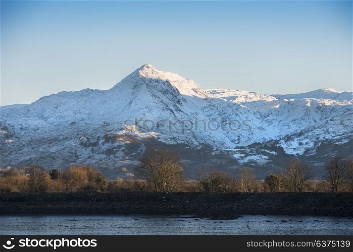 Beautiful Winter landscape image of Mount Snowdon and other peaks in Snowdonia National Park