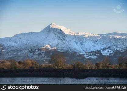 Beautiful Winter landscape image of Mount Snowdon and other peaks in Snowdonia National Park