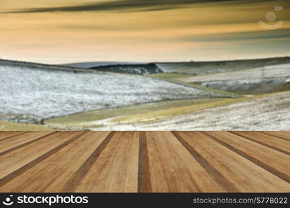 Beautiful Winter landscape over countryside with wooden planks floor