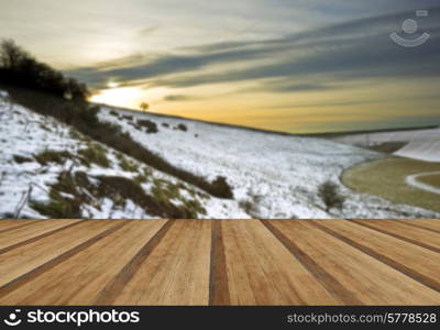 Beautiful Winter landscape over countryside with wooden planks floor