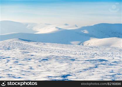 Beautiful winter landscape with snow mountains and blue sky