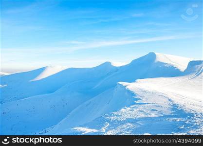 Beautiful winter landscape with snow mountains under blue sky