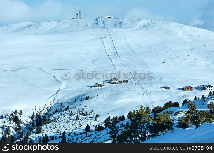 Beautiful winter mountain landscape with ski lift and ski run on slope. All people are not identify.