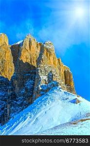 Beautiful winter mountain landscape with sunshine in blue sky (Sella Pass , Italy).