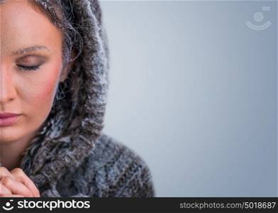 Beautiful Winter Woman with frost makeup on blue background