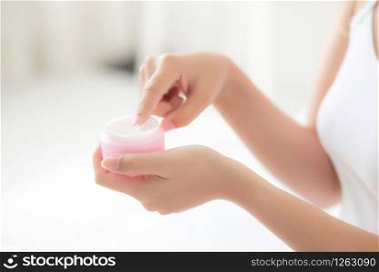 Beautiful with closeup hand asian woman applying moisturizer or lotion skin care cream cosmetic product, girl with treatment moisturizing body care, health and wellness concept.