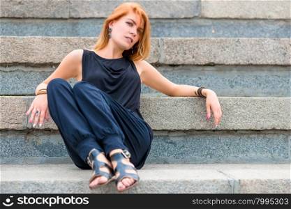 beautiful woman 30 years old sitting on the steps
