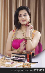 Beautiful woman admiring her jewelery