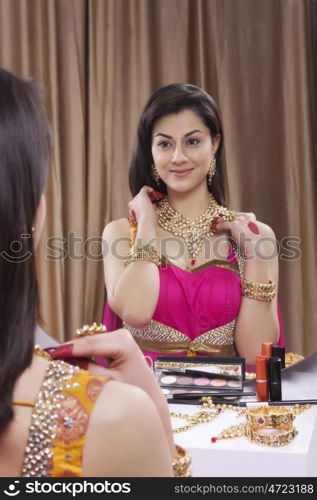 Beautiful woman admiring her jewelery