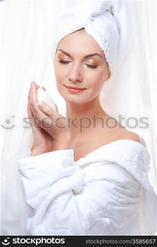 Beautiful woman after shower holding a soap