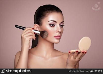 Beautiful Woman applies Skin Tone with Brush. Beautiful Woman applies Skin Tone with Brush. Beautiful Woman face. Perfect Makeup. Skincare Foundation. Brushes Makeup Artist