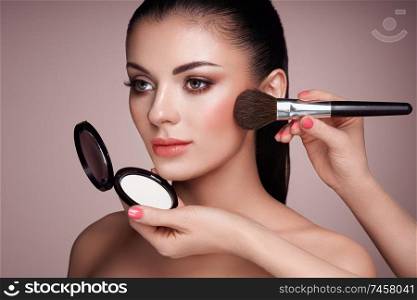 Beautiful Woman applies Skin Tone with Brush. Beautiful Woman face. Perfect Makeup. Skincare Foundation. Brushes Makeup Artist