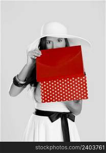Beautiful woman astonished after peeking to inside of the red box