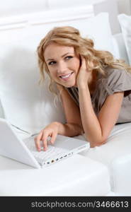 Beautiful woman at home using laptop computer