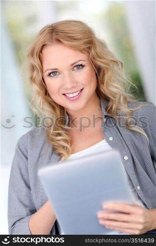 Beautiful woman at home websurfing with digital tablet