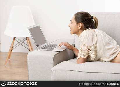 Beautiful woman at home working on her laptop