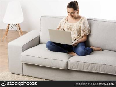 Beautiful woman at home working on her laptop