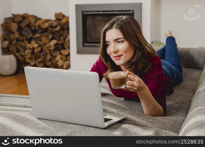 Beautiful woman at home working while drinking one capuchino