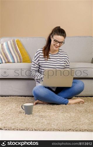 Beautiful woman at home working with a laptop