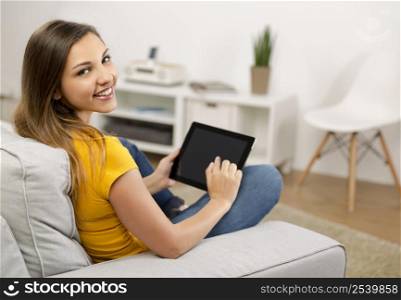 Beautiful woman at home working with a tablet