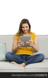 Beautiful woman at home working with a tablet