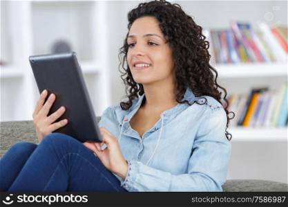 beautiful woman at home working with a tablet