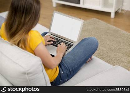 Beautiful woman at home working with her laptop