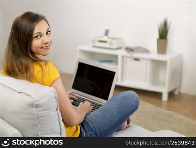 Beautiful woman at home working with her laptop