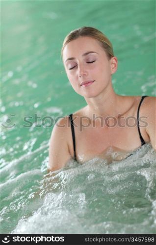 Beautiful woman bathing in spa pool