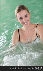 Beautiful woman bathing in spa pool