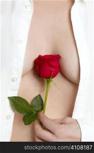 Beautiful woman body holding in hand a red rose