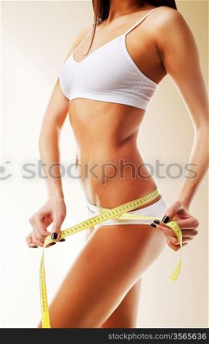 Beautiful woman body in white with yellow measure