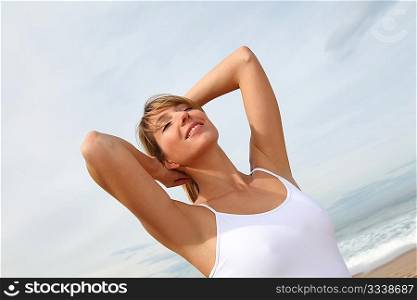 Beautiful woman breathing fresh air at the beach