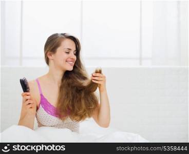 Beautiful woman checking hair ends