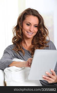 Beautiful woman connected on internet with electronic tablet