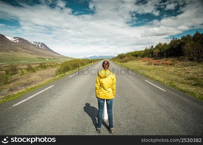 Beautiful woman contemplating a beautiful road surrounded by nature