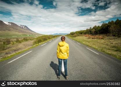 Beautiful woman contemplating a beautiful road surrounded by nature