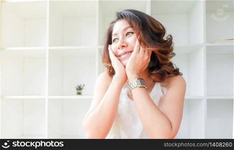 Beautiful woman covers face with two hands