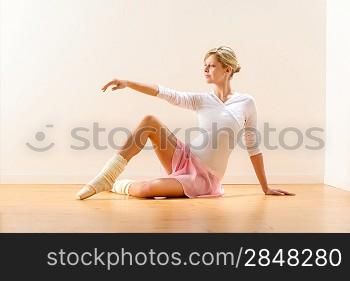 Beautiful woman dancer practicing ballet in studio ballerina arm raising
