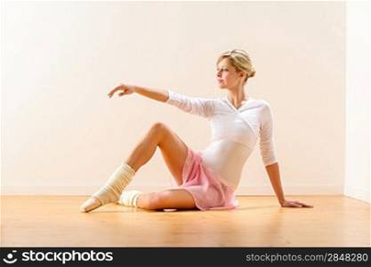 Beautiful woman dancer practicing ballet in studio ballerina arm raising