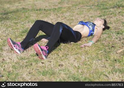 Beautiful woman doing stretching exercises in the park