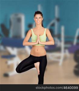 Beautiful woman doing yoga in the gym