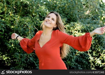Beautiful woman dressed in red relaxed in nature