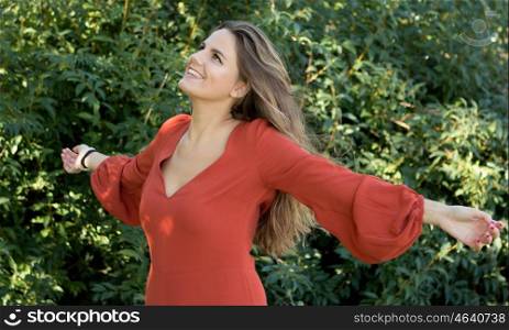 Beautiful woman dressed in red relaxed in nature