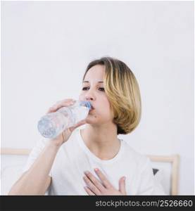 beautiful woman drinking water from bottle