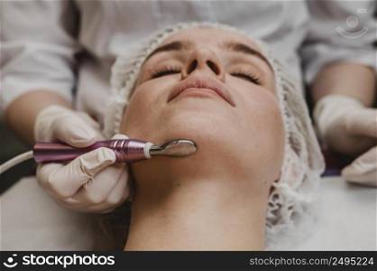beautiful woman during cosmetic treatment wellness center