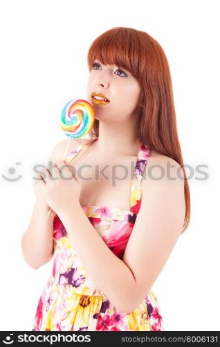 Beautiful woman eating a lollipop, over white background