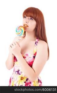 Beautiful woman eating a lollipop, over white background