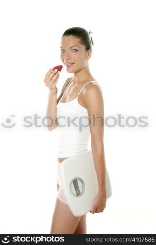Beautiful woman eating a red strawberry over white background