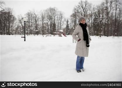Beautiful woman enjoying a winter day full of snow